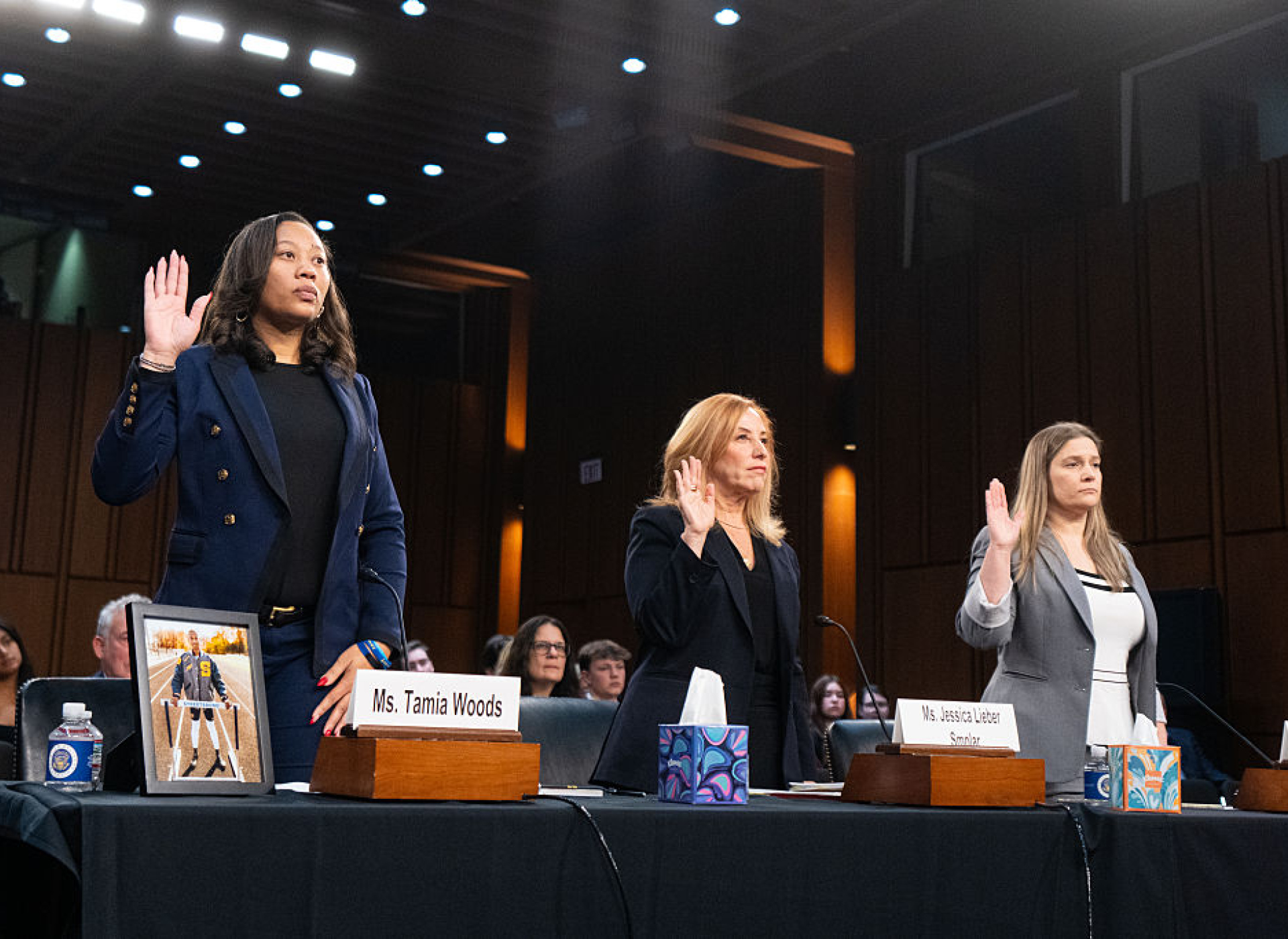 three women stand with their right hands raised, prepared to testify (getty images)